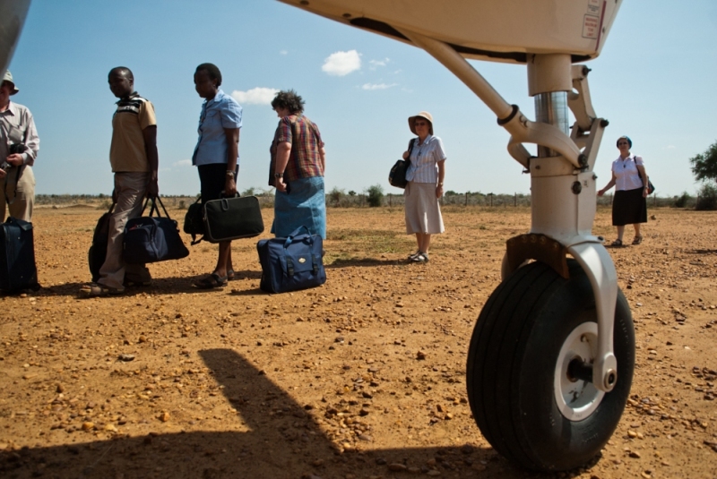 Passengers board at Kaabong Airstrip in Northern Uganda while Karamojong boys watch.
