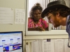 Pilot Ian Purdey helps a woman with a plane reservation at Elcho Island.