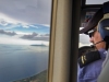 MAF pilot John Lowe  flies home over the ocean in East Timor.