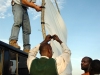 Jon Cadd, MAF pilot in Bunia, DR Congo, helps a local church set up an outdoor screen for showing a Christian movie.