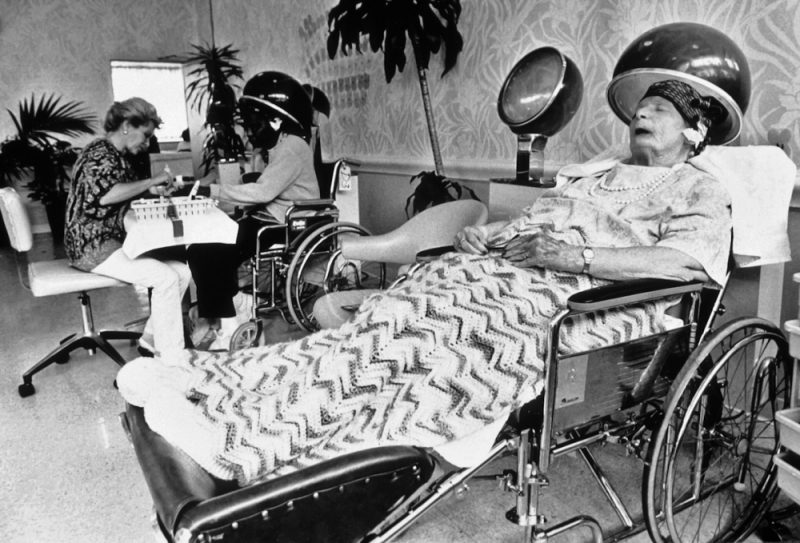 A resident of a long-term care facility in San Francisco has her hair done at the salon on the campus.