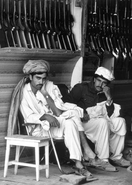 Two Pashtun shopkeepers sit in their store in the town of Darra Adam Khel, south of Peshawar in Pakistan. Darra is known for its production of weapons. Nearly every shop on the main street is a gun store selling a variety from anti-aircraft guns to pen-guns.